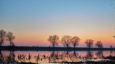        Nehir, ağaçlar ve gökyüzü gün batımında                        