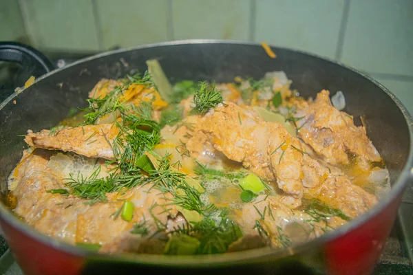 Meat with onions, carrots, dill and Bay leaf is stewed in a saucepan. Home cooking. — Stock Photo, Image