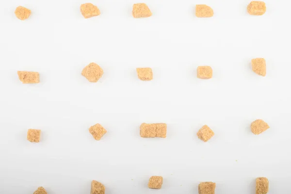 Pieces of brown sugar on a white background.