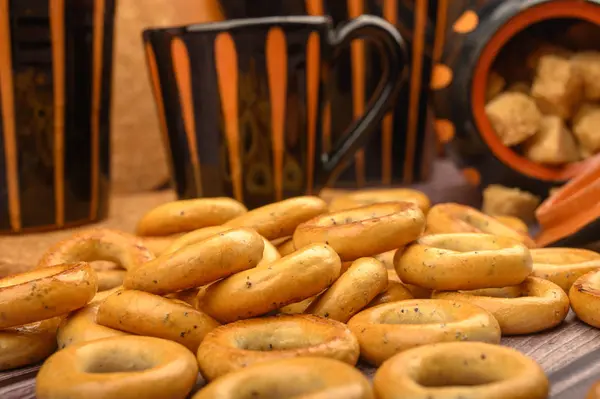 Pequenos bagels, açúcar mascavo e pratos de cerâmica em um fundo de madeira close-up . — Fotografia de Stock