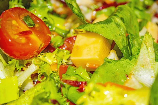 Gemüsesalat mit Tomaten, Gurken, Paprika, Zwiebeln, Rucola mit Käsewürfeln. gesunde Ernährung, Fitness-Ernährung. Nahaufnahme. — Stockfoto