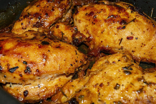Chicken breast baked with spices in the oven. Close up
