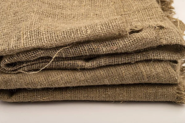 A few pieces of burlap. Fabric with a rough texture for sewing bags. surface texture Close-up