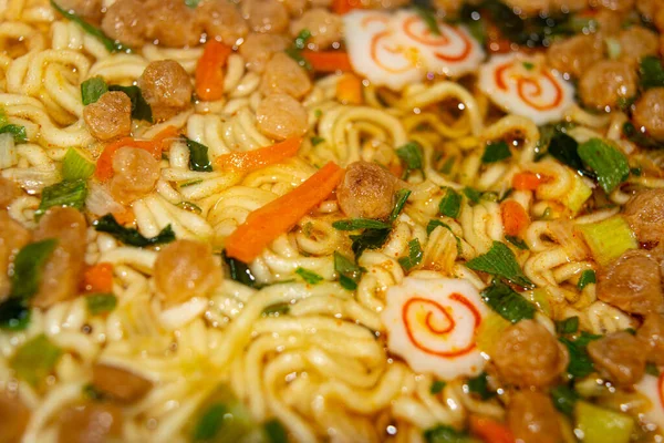 Instant noodles with spices, dried vegetables and freeze-dried meat filled with boiling water. Close up