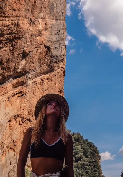 woman looking at the sky, half mountain and sky
