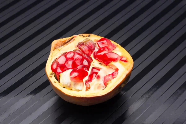 Open pomegranate, full of red, sweet, crispy and tasty beans