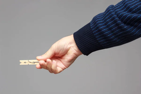 Clothespin in the hand of an adult