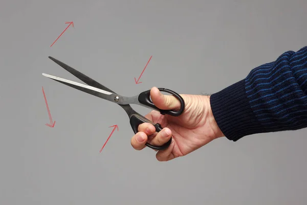 Scissors in a person's hand — Stock Photo, Image