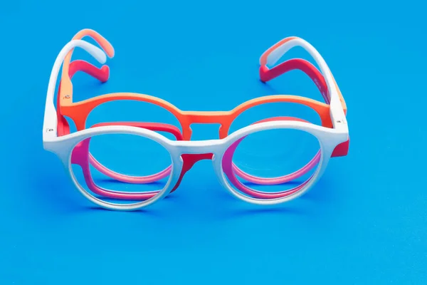 Colored glasses on plain background, modern glasses for fashion.