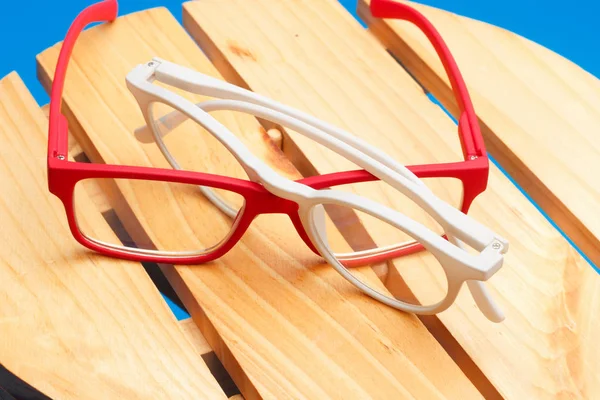 Colored glasses on plain background, modern glasses for fashion.