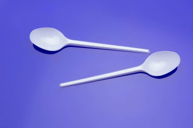 Küçük kahve kaşığı, plastik çatal ve beyaz. Küçük nesneler yemek ve yemek yemek için ve kahve koymak için şeker porsiyonları ölçüsü olarak kullanılır. Yiyecek nesneler ve çatallar.