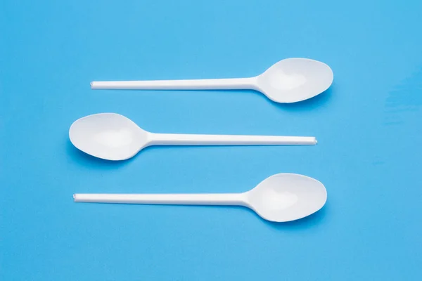 Cutlery for eating white and made of plastic and transparent glass cups; Cutlery and glasses teaspoons for coffee and for rationing small amounts of sugar, fork for pricking food, glasses for drinking