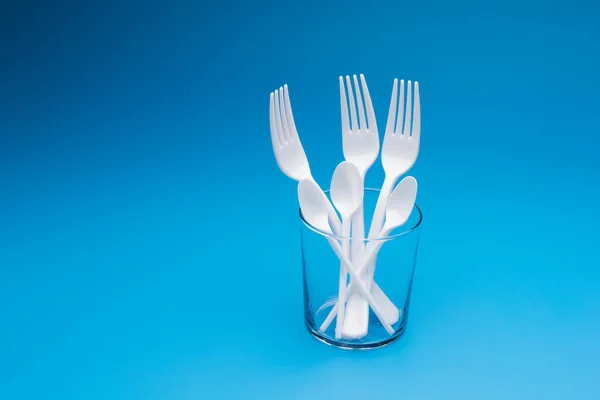 Cutlery for eating white and made of plastic and transparent glass cups; Cutlery and glasses teaspoons for coffee and for rationing small amounts of sugar, fork for pricking food, glasses for drinking