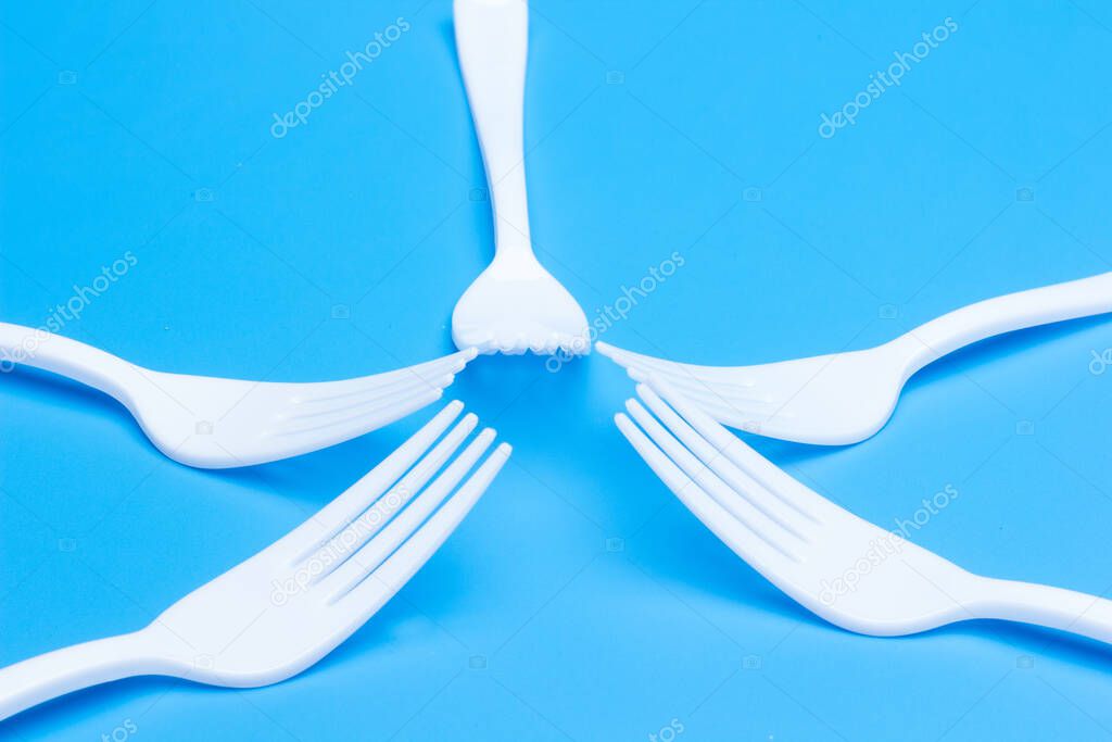 plastic tableware for picnics, parties and informal meals. White plastic disposable holders for use and disposal.