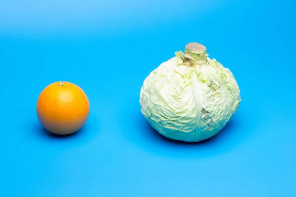 Citrus and winter vegetables, orange versus pale green, orange and cabbage, winter, healthy and healthy products important for a good diet
