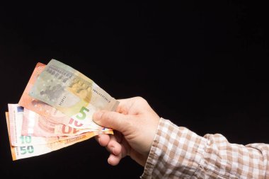 Avro banknotları, satın almaya ya da tasarruf etmeye ve bankaya girmeye hazır bir kişinin elinde. Yasal ihale banknotları, Avrupa para birimi.