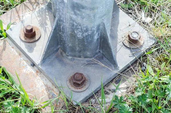 The big nut is screwed to the concrete — Stock Photo, Image