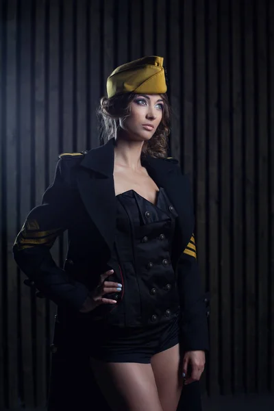 Portrait of girl in a black aviator uniform with hat — Stock Photo, Image