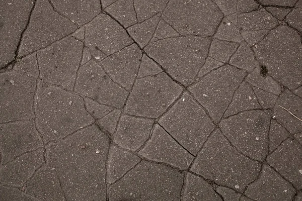 Old road background - surface of grey cracked asphalt texture — Stock Photo, Image
