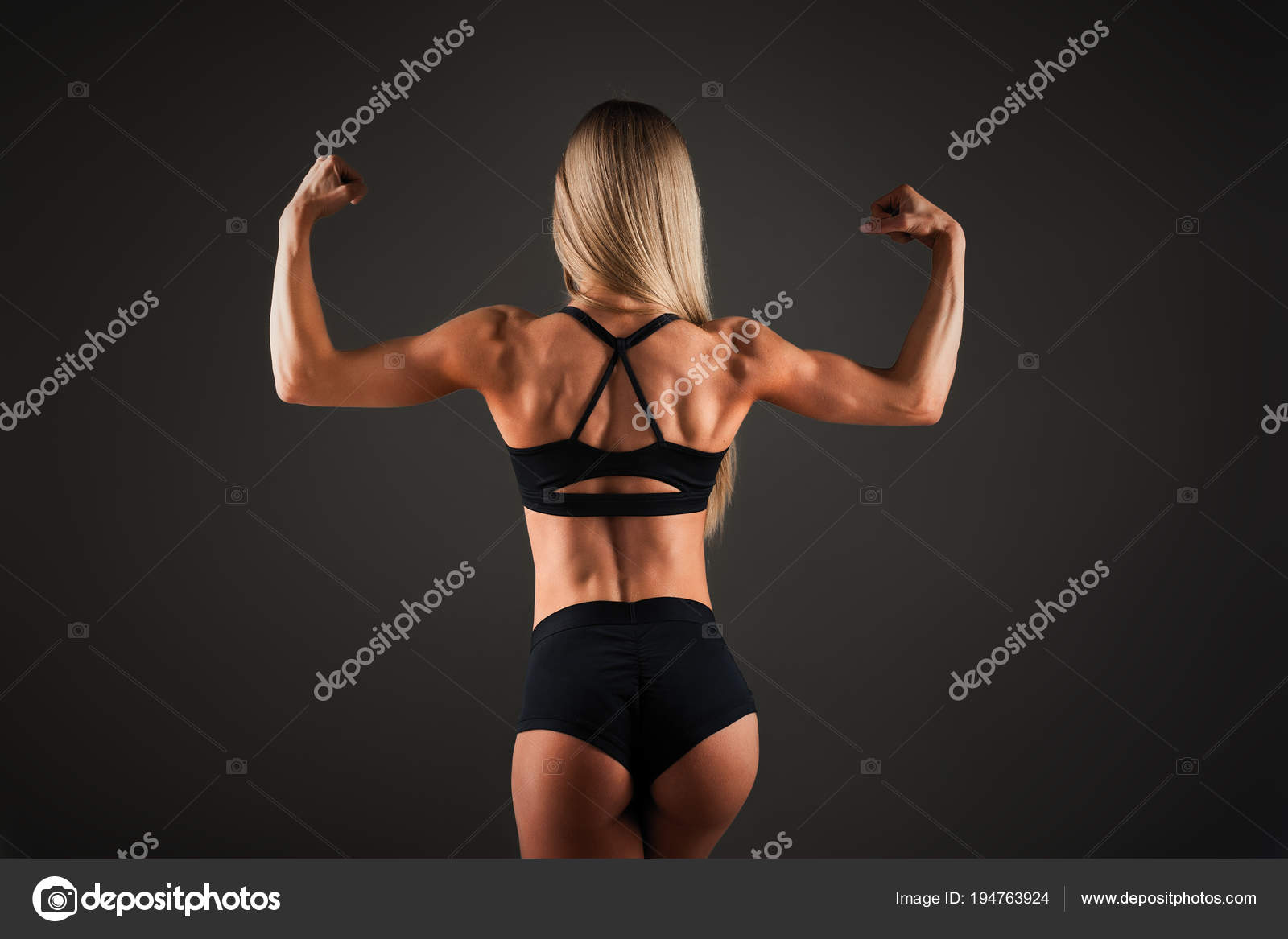 Strong Athletic woman Fitness Model posing back muscles, triceps