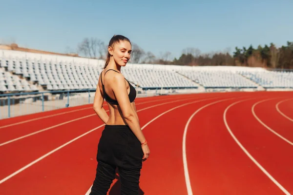 Look Good and feel great. Seen from behind healthy woman jogger in sport style clothes on the stadium in the morning running — Stock Photo, Image