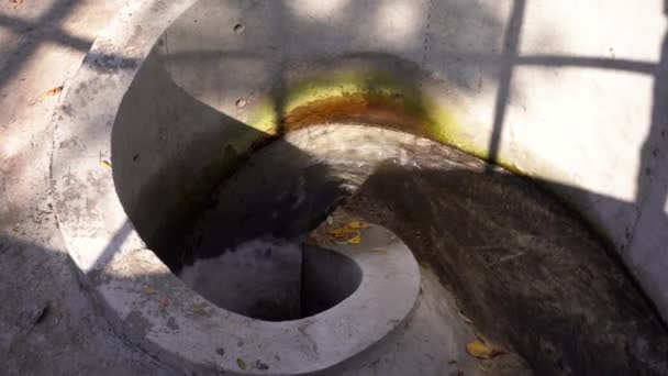 Water whirlpool flows from the lake to the drainage under the ground in a spiral. water funnel — Stock Video