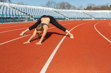Genç fitness kadın runner yolda çalıştırmadan önce ısınmak. Sabah egzersizleri, yaz
