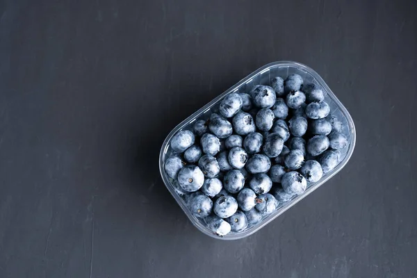 Tasty Juicy Raw Blueberries Plastic Container Black Dark Background Packaging — Stock Photo, Image