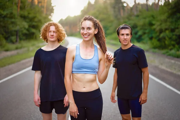 Group Three People Athletes One Girl Two Men Standing Asphalt — Stock Photo, Image