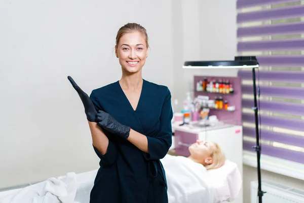 Cosmetology Cabinet Client Lies Couch Beautician Stands Puts Black Gloves — Stock Photo, Image