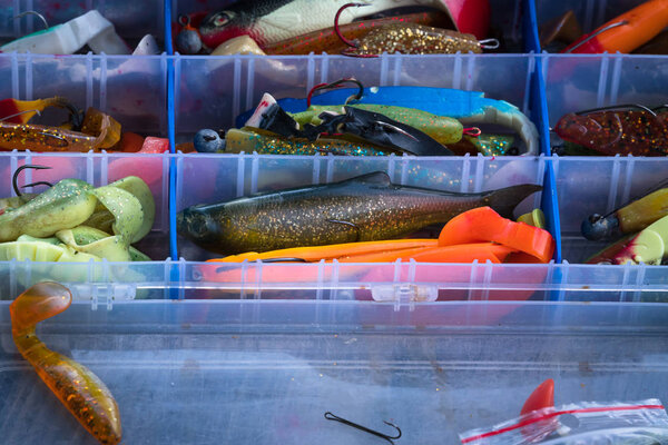 fishing tackle box with various colored rubber wobblers
