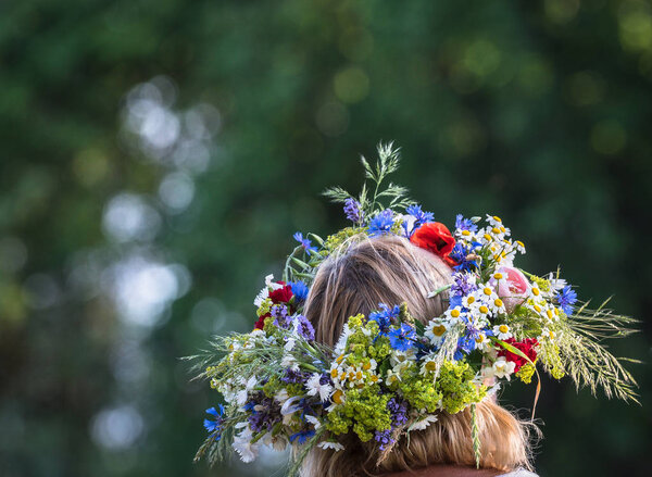 summer solstice wreath on head, handmade, individual parts in focus, summer day
