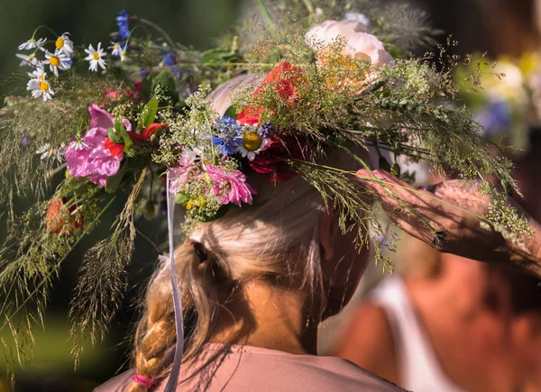 summer solstice wreath on head, handmade, individual parts in focus, summer day
