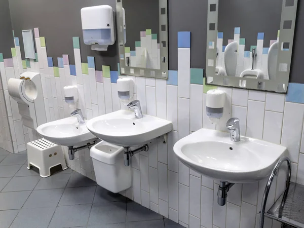 Some urinals in a public restroom — ストック写真