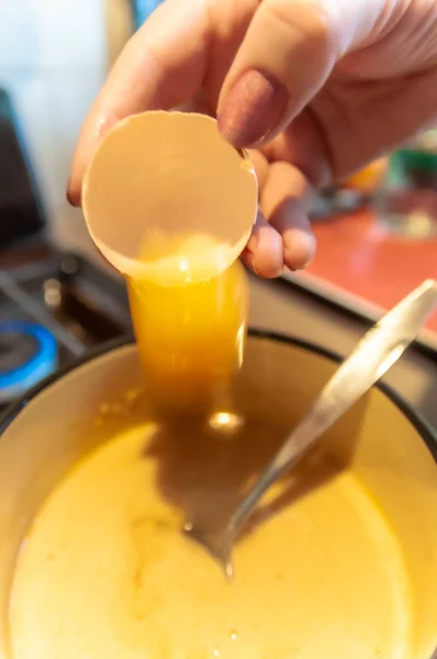 Preparation of dough for baking. adding an egg to the dough. — Stock Photo, Image