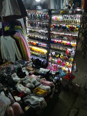 Dalat, Vietnam - December 12, 2019 Scene of crowded busy night marketplace with street vendor selling produce and wares on the sidewalk at Central Dalat Night 