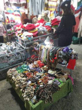 Dalat, Vietnam - December 12, 2019 Scene of crowded busy night marketplace with street vendor selling produce and wares on the sidewalk at Central Dalat Night 