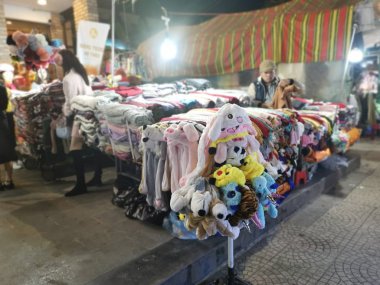 Dalat, Vietnam - December 12, 2019 Scene of crowded busy night marketplace with street vendor selling produce and wares on the sidewalk at Central Dalat Night 