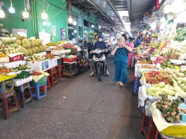 Ho Chi Minh City, Vietnam - December 15, 2019 Crowded daytime marketplace with street vendor selling variety produces- wet or day and wares on the sidewalk at Ho Chi Minh City market.
