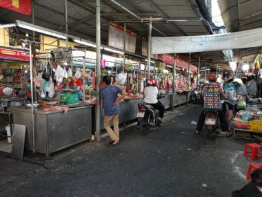 Ho Chi Minh City, Vietnam - December 15, 2019 Crowded daytime marketplace with street vendor selling variety produces- wet or day and wares on the sidewalk at Ho Chi Minh City market.