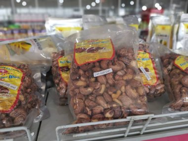 Ho Chi Minh City, Vietnam - December 15, 2019: Scene of stalls selling variety nuts, junk foods and jewellery are displayed and sold inside the Tong Thau APG Market at Ho Chi Minh City.
