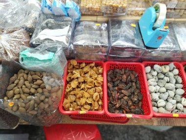 Ho Chi Minh City, Vietnam - December 15, 2019: Scene of stalls selling variety nuts, junk foods and jewellery are displayed and sold inside the Tong Thau APG Market at Ho Chi Minh City.