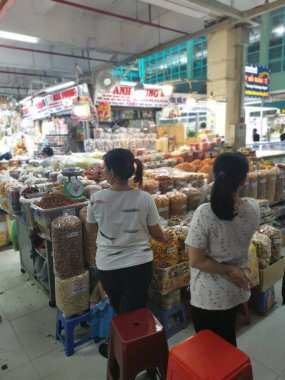 Ho Chi Minh City, Vietnam - December 15, 2019: Scene of stalls selling variety nuts, junk foods and jewellery are displayed and sold inside the Tong Thau APG Market at Ho Chi Minh City.