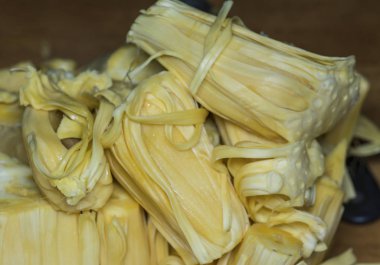 Bir Jackfruit kes ve lezzetli sarımsı soğanları ayır..