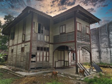 evening scene at the old double-storey  deserted wooden home.