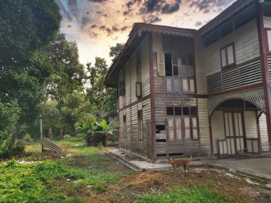 evening scene at the old double-storey  deserted wooden home.