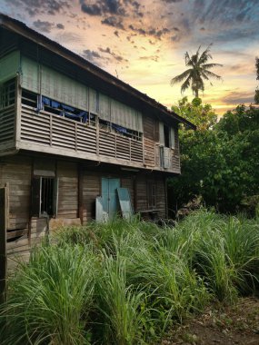 evening scene at the old double-storey  deserted wooden home.