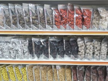 Perak, Malaysia. February 13,2020: Varieties of dried Asian seafood or snacks on displayed on shelves for sale at Pangkor Dried Seafood Supermarket.