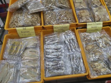Perak, Malaysia. February 13,2020: Varieties of dried Asian seafood or snacks on displayed on shelves for sale at Pangkor Dried Seafood Supermarket.