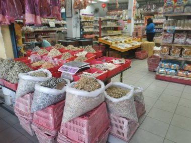 Perak, Malaysia. February 13,2020: Varieties of dried Asian seafood or snacks on displayed on shelves for sale at Pangkor Dried Seafood Supermarket.